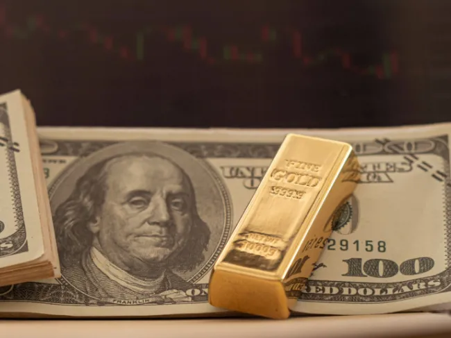 Gold bar and cash